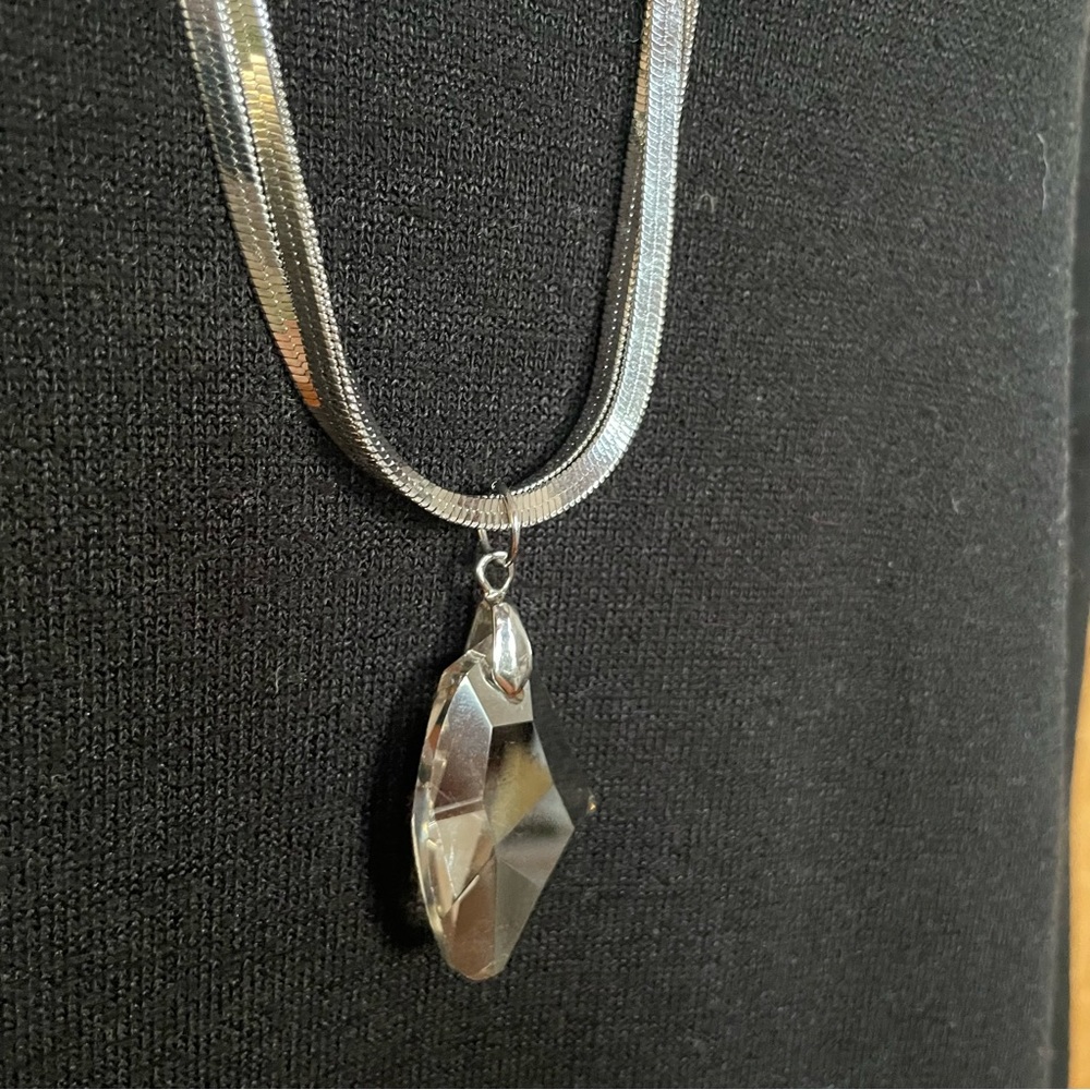Three-strand snake chain necklace with crystal drop. 29" adjustable to 31".